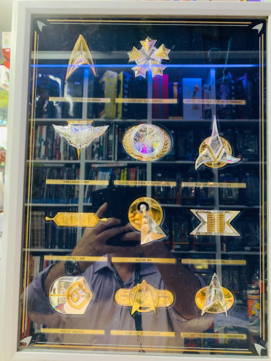 Star Trek Badges one missing in glass case
